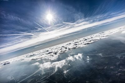 Aerial view of snow covered mountain against blue sky