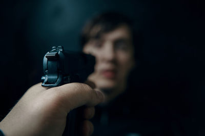 Close-up portrait of man holding camera