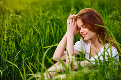 Portrait of young woman sitting on grass