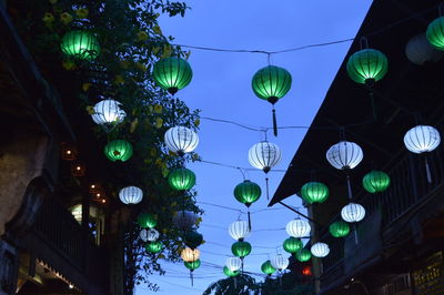 Low angle view of illuminated lanterns hanging at night