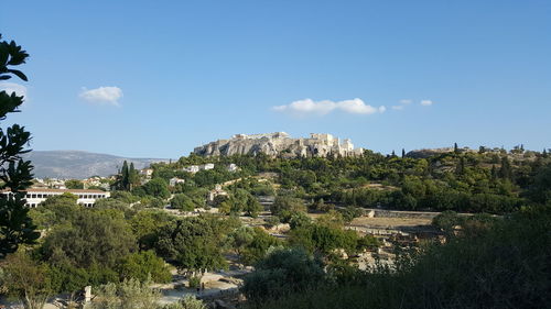 View of trees and mountain against blue sky