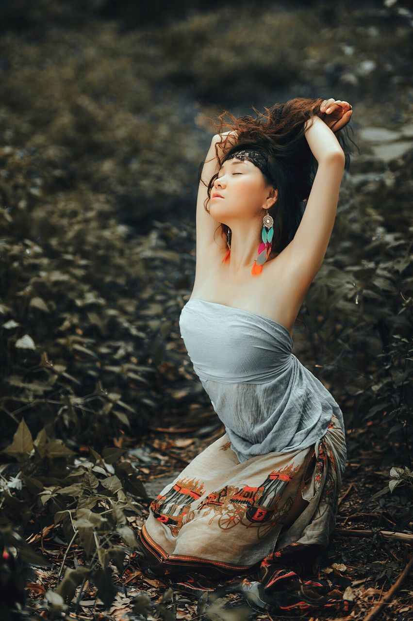 YOUNG WOMAN STANDING ON GROUND