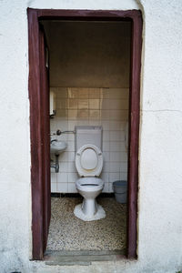 Close-up of open door on white wall