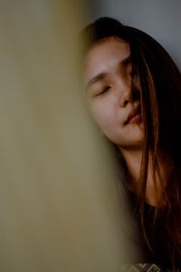 Close-up portrait of young woman looking away