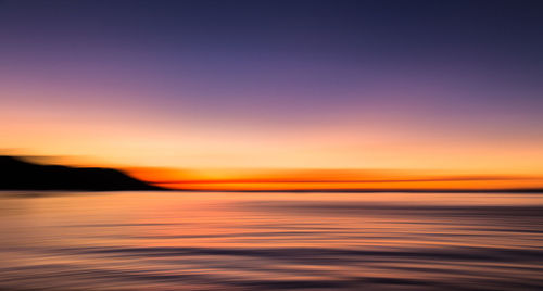 Scenic view of sea at sunset