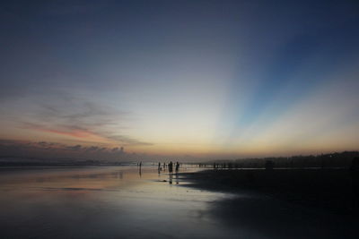 Scenic view of beach against sky during sunset