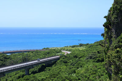 High angle view of sea and trees against sky