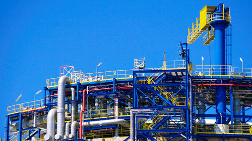 Illuminated bridge against clear sky at night