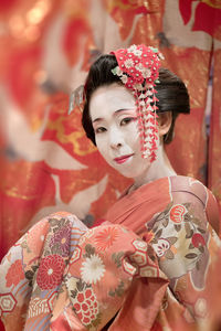 Portrait of woman with red flowers