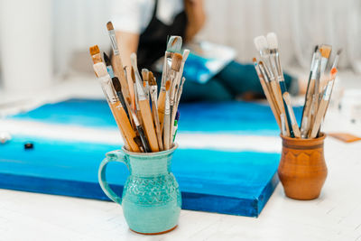 Woman painting on canvas at home