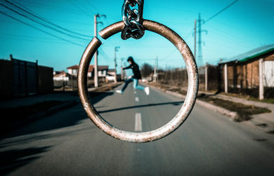 Close-up of motorcycle on road against sky