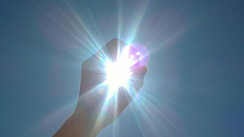 sun, sunbeam, lens flare, sunlight, low angle view, bright, blue, sunny, back lit, glowing, sky, brightly lit, shiny, part of, day, nature, one person, clear sky, beauty in nature