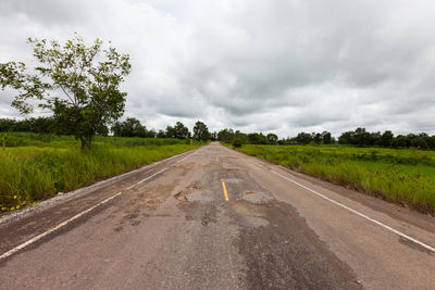 Empty road along countryside landscape