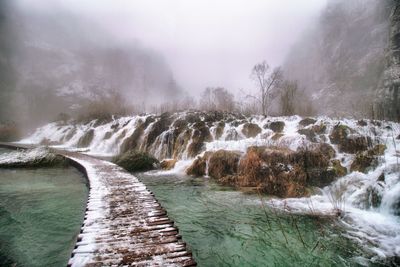 Scenic view of waterfall in river