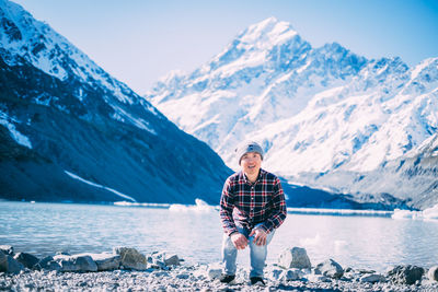 Full length of man on snowcapped mountain against sky