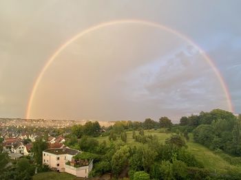 Scenic view of rainbow over buildings in city