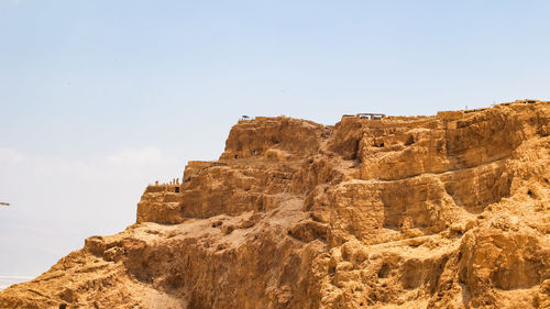 Low angle view of rock formations against sky