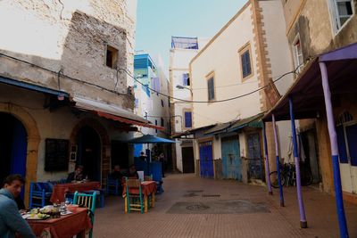 People on street amidst buildings in city