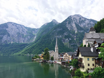 High angle view of lake amidst buildings against sky