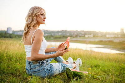 Portrait of a happy young woman enjoying and eating