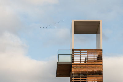 Low angle view of birds flying against sky