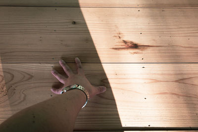 Shadow of person on wooden table