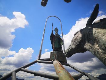 Low angle view of chain against sky