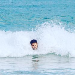 Portrait of man swimming in sea