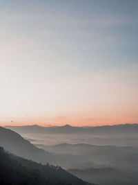 Scenic view of silhouette mountains against sky during sunset