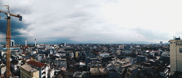 Cityscape against cloudy sky