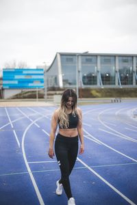 Full length of woman with arms raised