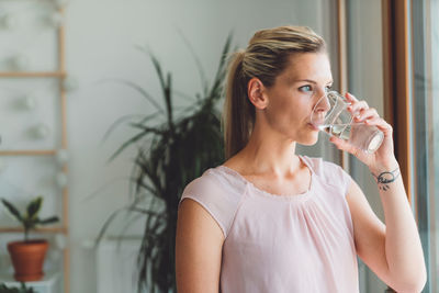 Young woman drinking glass