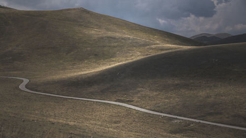 Scenic view of mountain road against sky