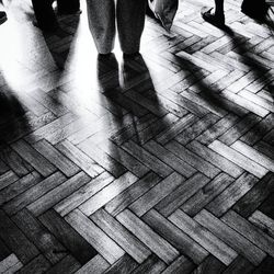 Low section of people standing on tiled floor