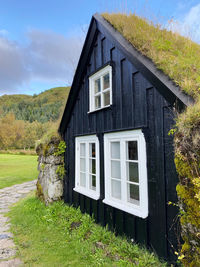 House on field with window black house grassy nature living comfortable park tiny house green land 