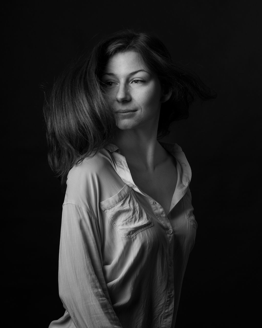 studio shot, black background, one person, indoors, young adult, women, standing, young women, front view, adult, hairstyle, long hair, beauty, waist up, portrait, casual clothing, beautiful woman, looking at camera, lifestyles, hair, contemplation