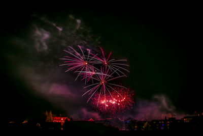 Low angle view of firework display at night