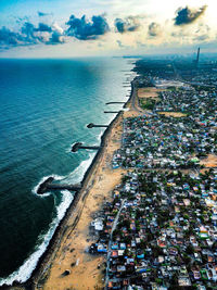 High angle view of buildings by sea against sky