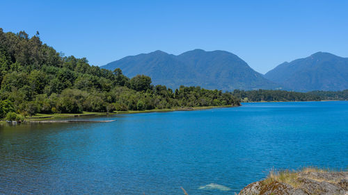 Scenic view of mountains against clear blue sky