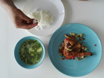 Cropped image of person having food on table at home