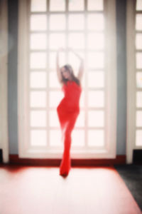 Full length of woman standing by railing