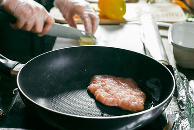 Close-up of person preparing food in kitchen