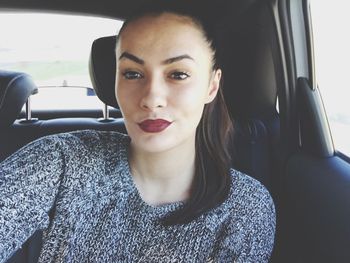 Portrait of woman sitting in car