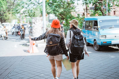 Rear view of woman walking on street