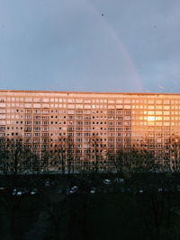 Buildings against sky seen through glass window