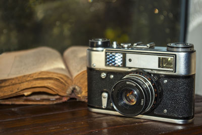 Close-up of old camera on table