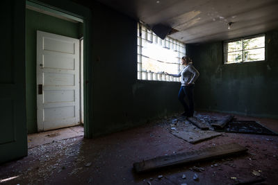 Full length of person in ruined house