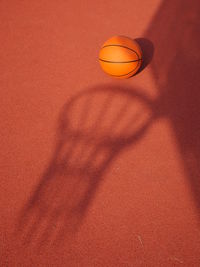 Shadow of basketball hoop on court