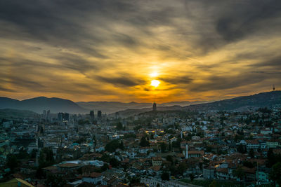 Aerial view of townscape against sky during sunset