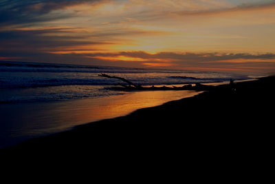 Scenic view of sea against orange sky